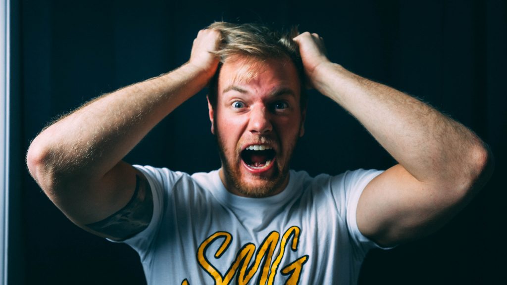 Men hold his head and screaming